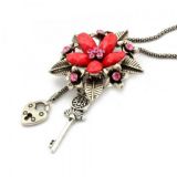 Metal necklace with flower design and shimmering rhinestones