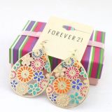 Striking earrings with a flower ornament