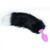 Pink butt plug with long black and white tail